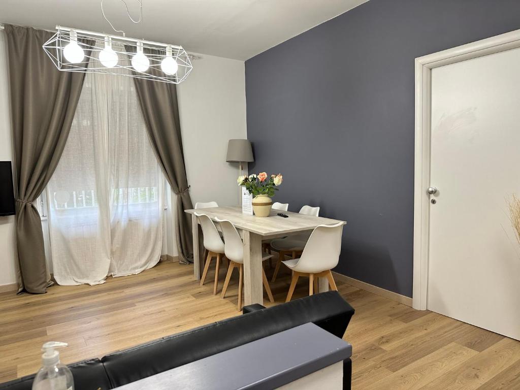 a dining room with a white table and chairs at Shabby Chic Flat Monte Mario in Rome