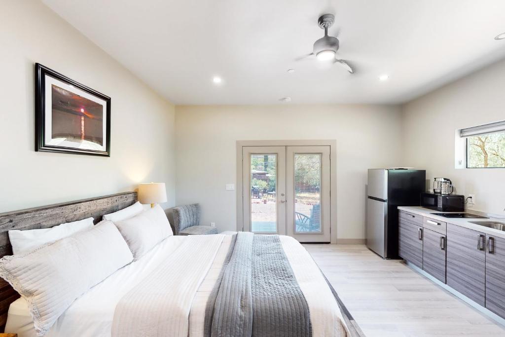 a bedroom with a large bed and a refrigerator at Moondance Manor, Unit B in Sedona