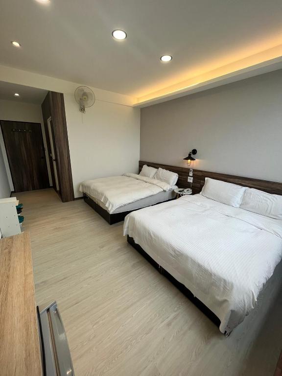 a hotel room with two beds in a room at Dongshan River Resort Farm in Wujie