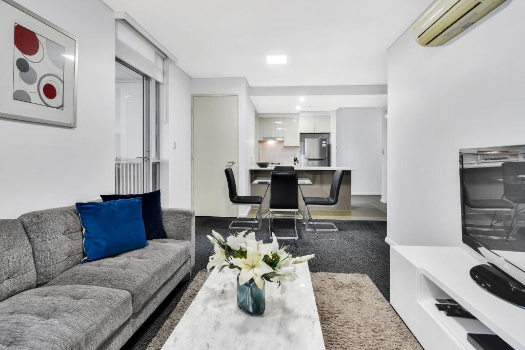 a living room with a couch and a table at Corporate Apartment North Sydney MIL2251306 in Sydney