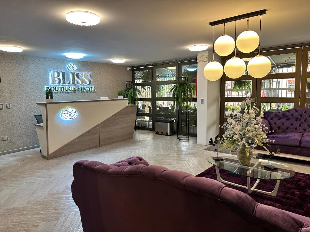 a lobby with a couch and a reception desk at BLISS BOUTIQUE HOTEL BOGOTA in Bogotá