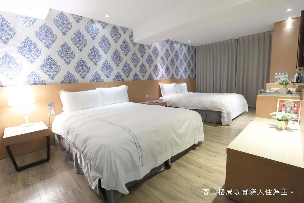 Postel nebo postele na pokoji v ubytování Talmud Hotel Yizhong