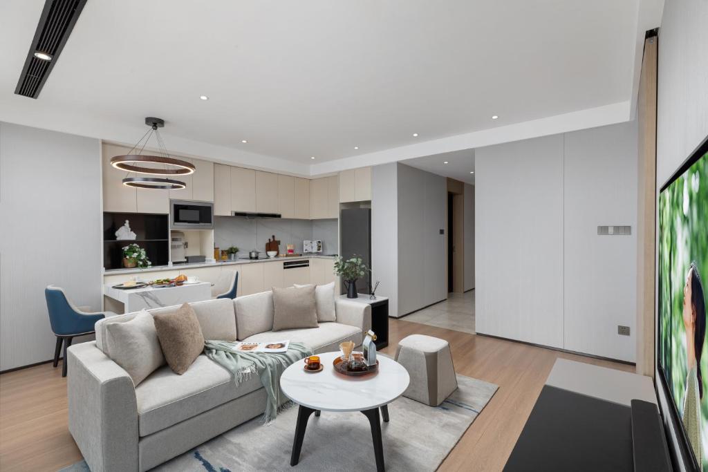 a living room with a couch and a table at Somerset Taihu New City CBD Wuxi in Wuxi