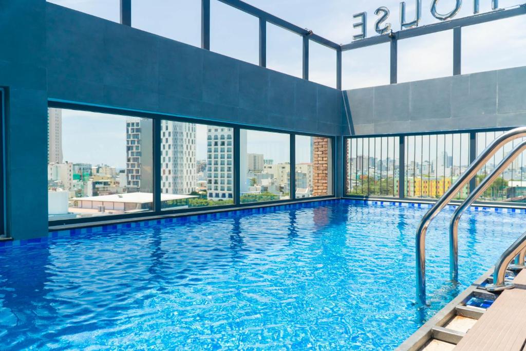 a swimming pool with a view of a city at Lantana House Boutique Da Nang by Haviland in Da Nang