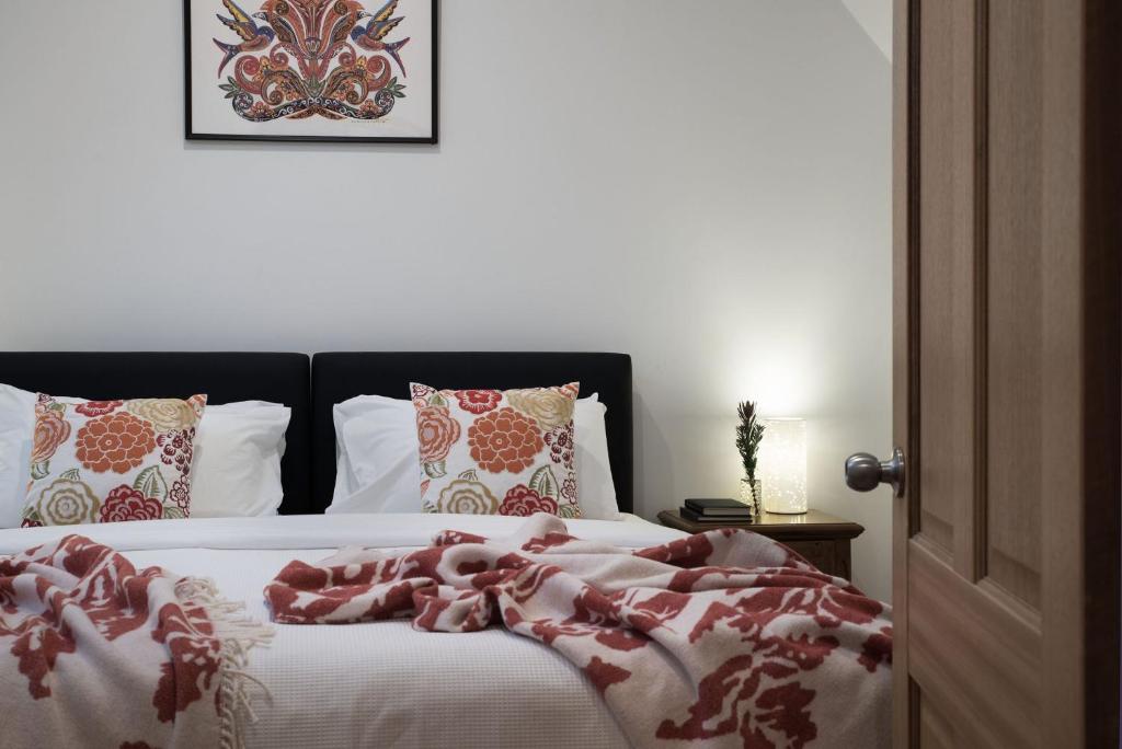 a bedroom with a bed with a red blanket on it at Abbotts Rest in Hepburn Springs