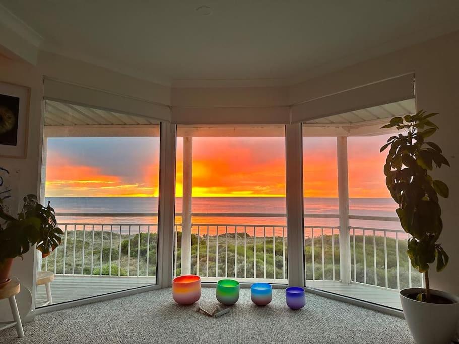 a room with a large window with a view of the ocean at Arcadia Beachfront Retreat in Mandurah