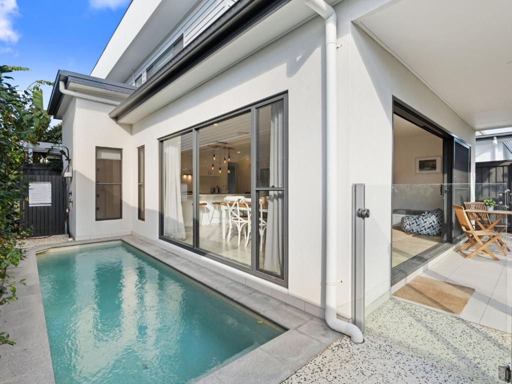 a swimming pool in the backyard of a house at Beach Pad on Nautilus in Kingscliff