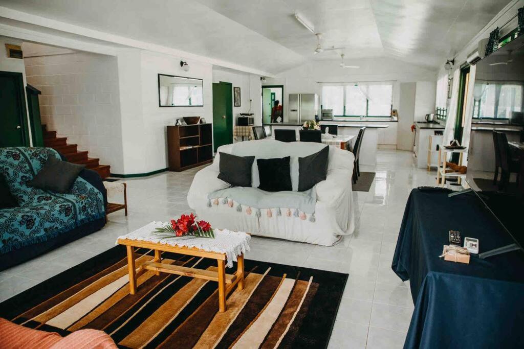 a large living room with a bed and a table at Heavenly Home in Apia