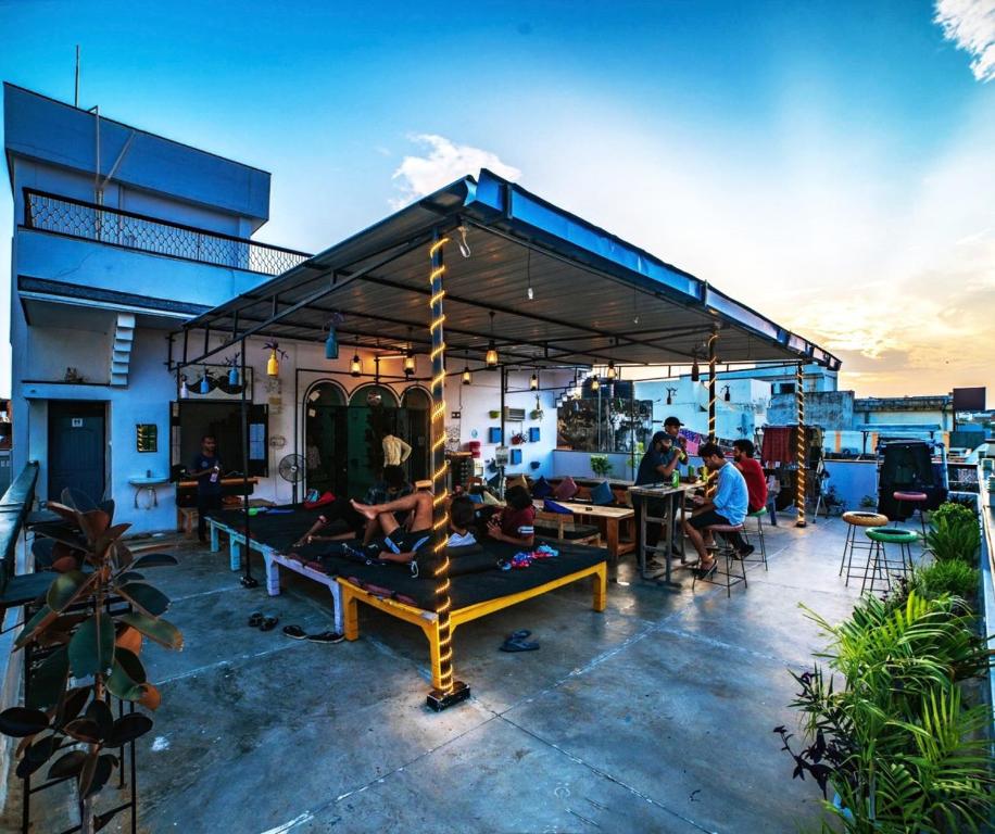 a group of people sitting on a rooftop patio at Moustache Varanasi in Varanasi