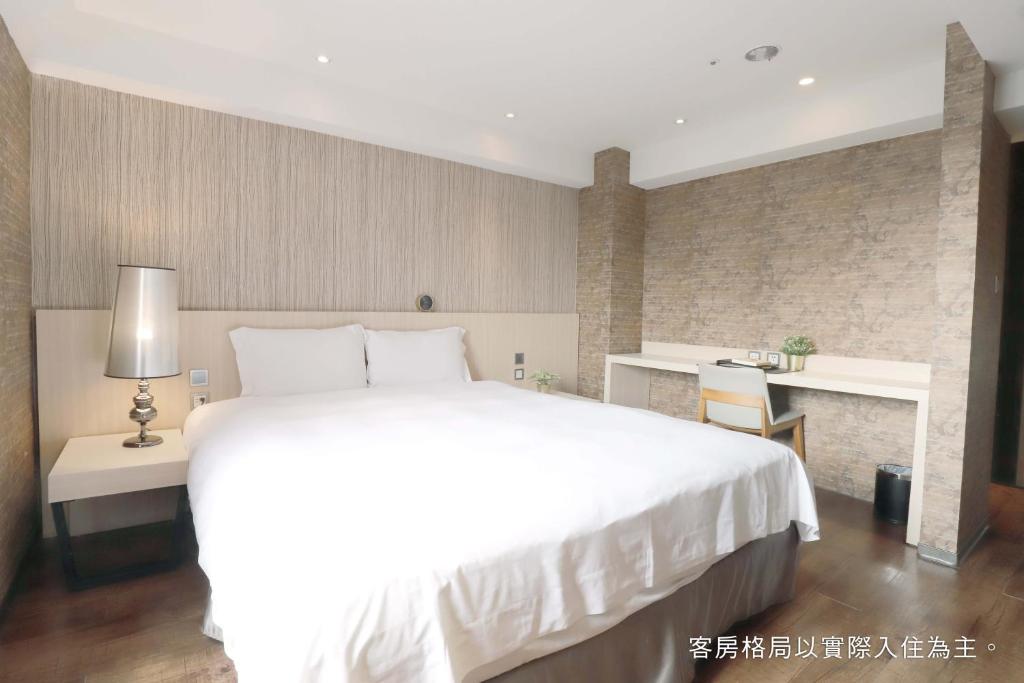 Postel nebo postele na pokoji v ubytování Talmud Hotel Yizhong