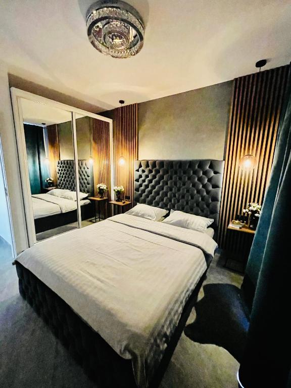 a bedroom with a large bed and a large mirror at Aici te simți ca acasa in Iaşi