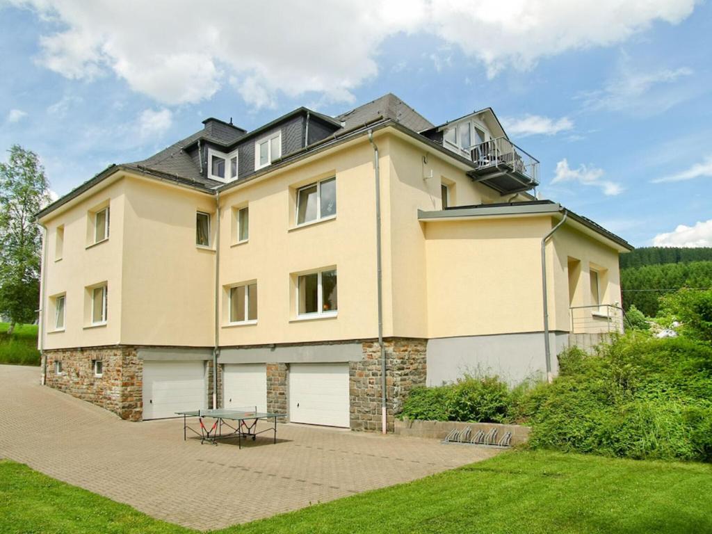 a large house with a roof at Large apartment in the beautiful Sauerland with garden patio and sauna in Erndtebrück