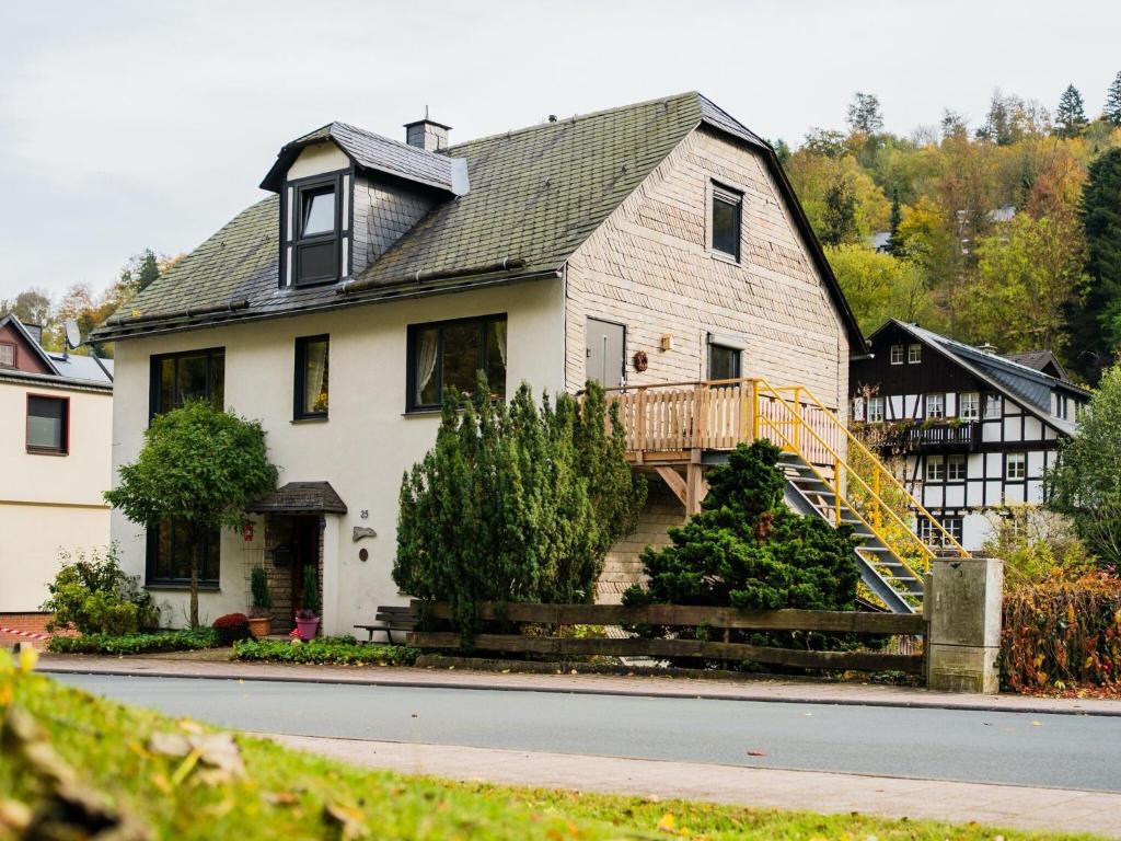 a large white house with a porch and a deck at Large detached holiday home in Willingen with garden in Willingen