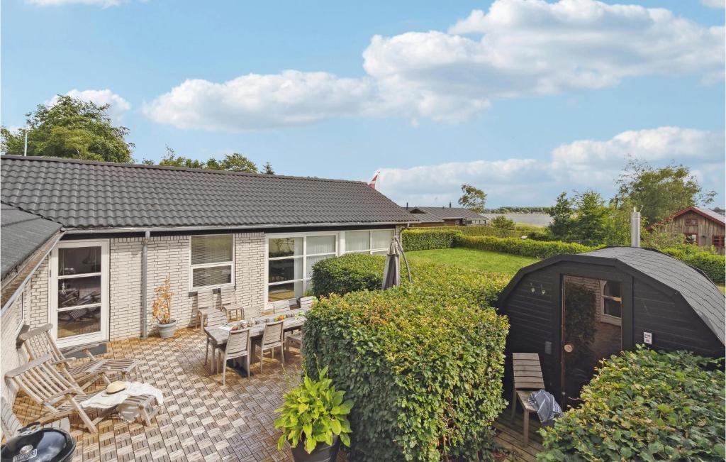 a house with a garden and a black shed at Gorgeous Home In Sunds With Kitchen in Sunds