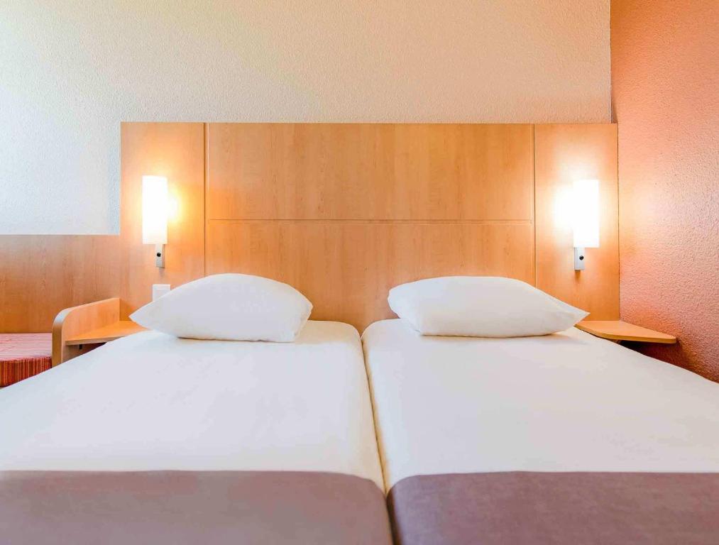Postel nebo postele na pokoji v ubytování ibis Besançon Marchaux