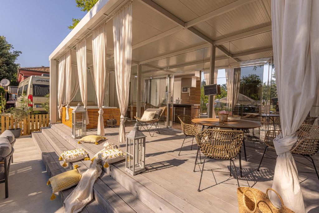 a covered deck with a table and chairs at Polidor Camping Resort in Poreč