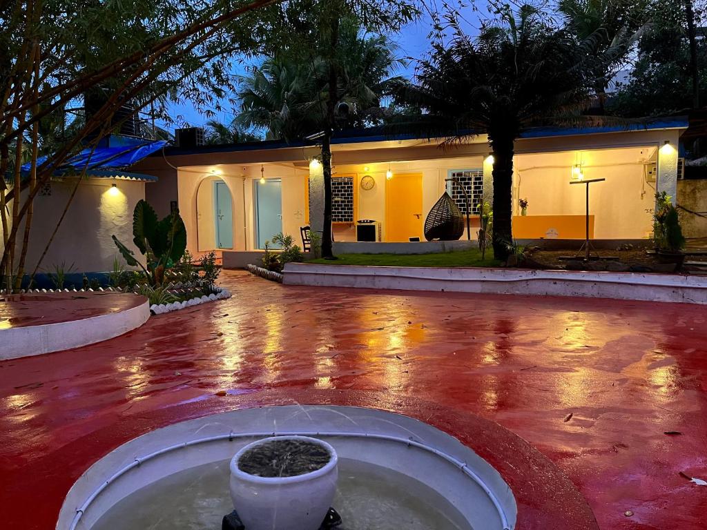 a house with a fountain in the middle of a yard at Endless Blue Hostel 