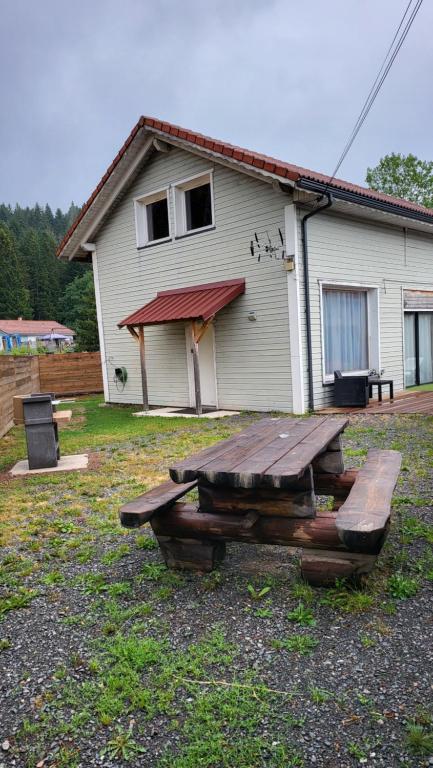 a picnic table in front of a house at ROMANN 2 in Xonrupt-Longemer
