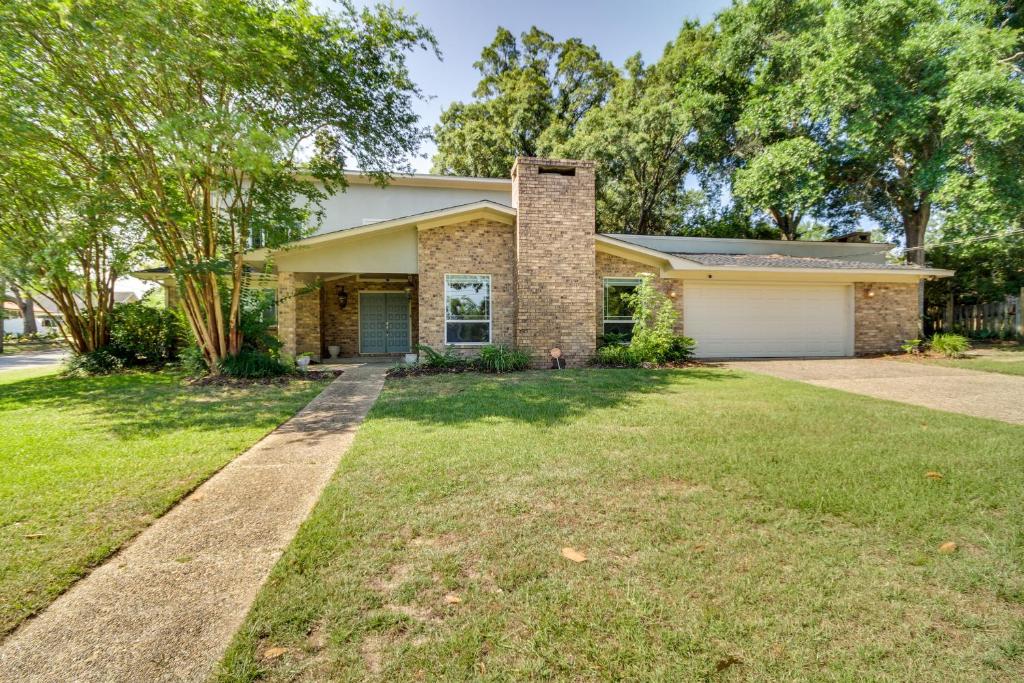 a house with a driveway and a garage at Spacious Biloxi Home with Patio and Private Yard! in Biloxi