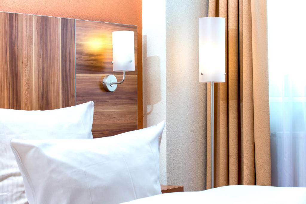 Postel nebo postele na pokoji v ubytování Best Western Hotel Braunschweig Seminarius