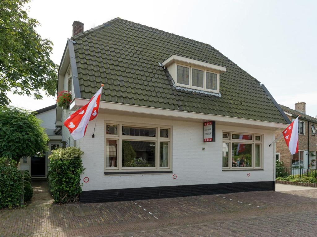 a house with two canadian flags in front of it at Alluring Apartment in Bergen with Terrace Garden and BBQ in Bergen