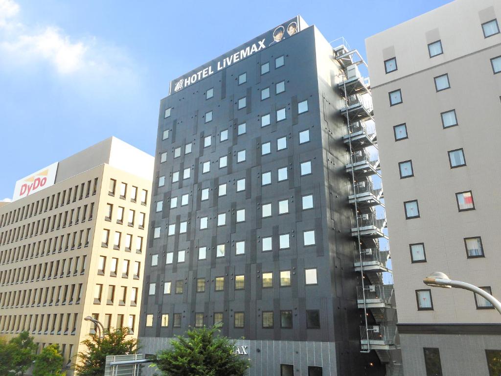 a building with a fire on the side of it at Hotel Livemax Premium Nagano Ekimae in Nagano