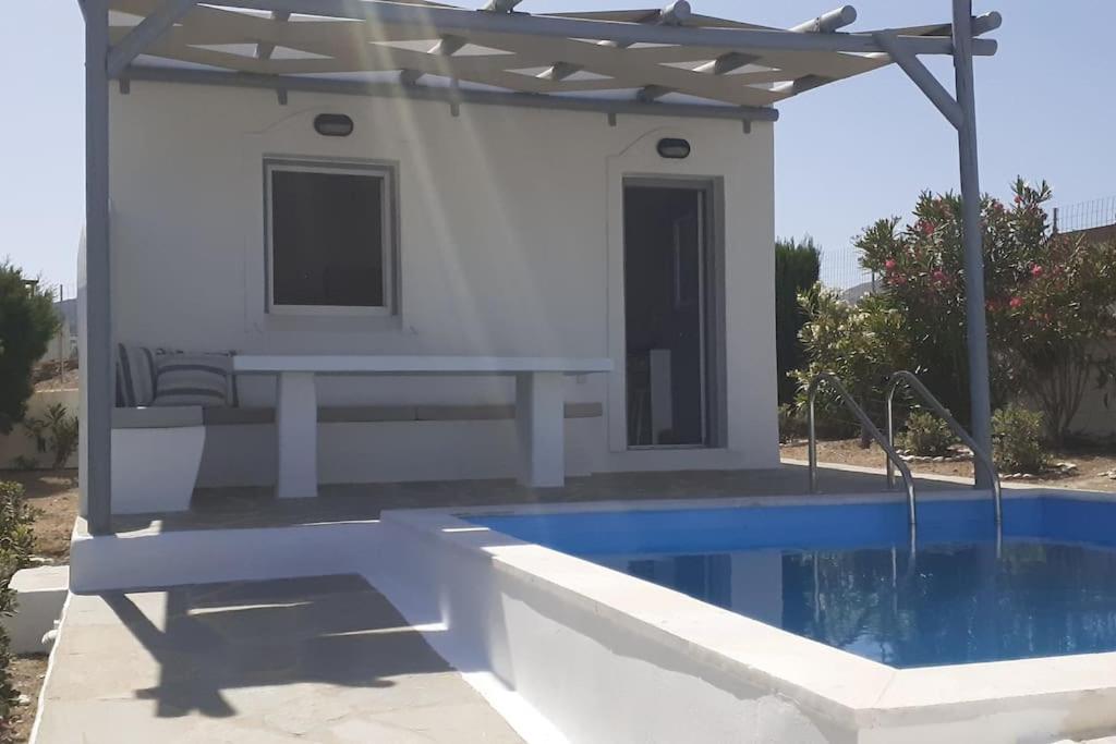 a villa with a swimming pool and a house at Studio Angelika in Glinado Naxos