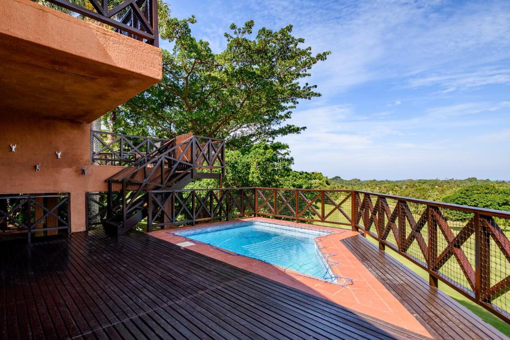a deck with a swimming pool on top of a house at San Lameer Villa 14108 - 4 Bedroom Classic - 8 pax - San Lameer Rental Agency in Southbroom