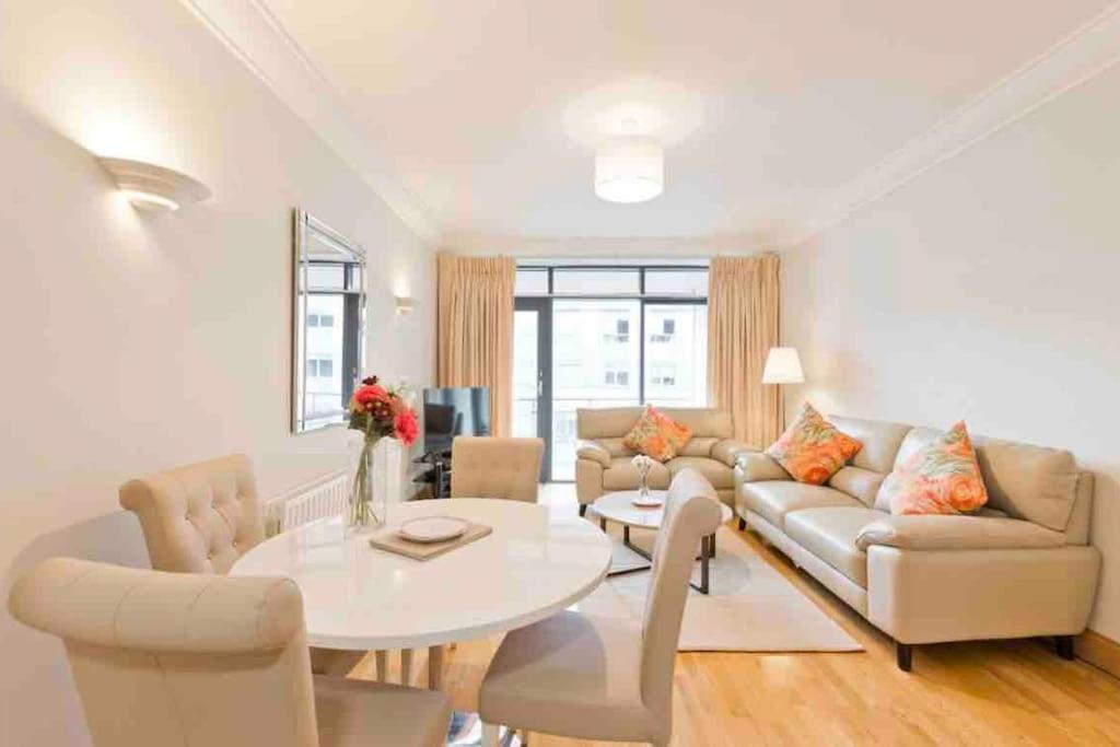 un soggiorno bianco con tavolo e sedie bianchi di Luxury Two Bedroom Apt in Dublin a Dublino