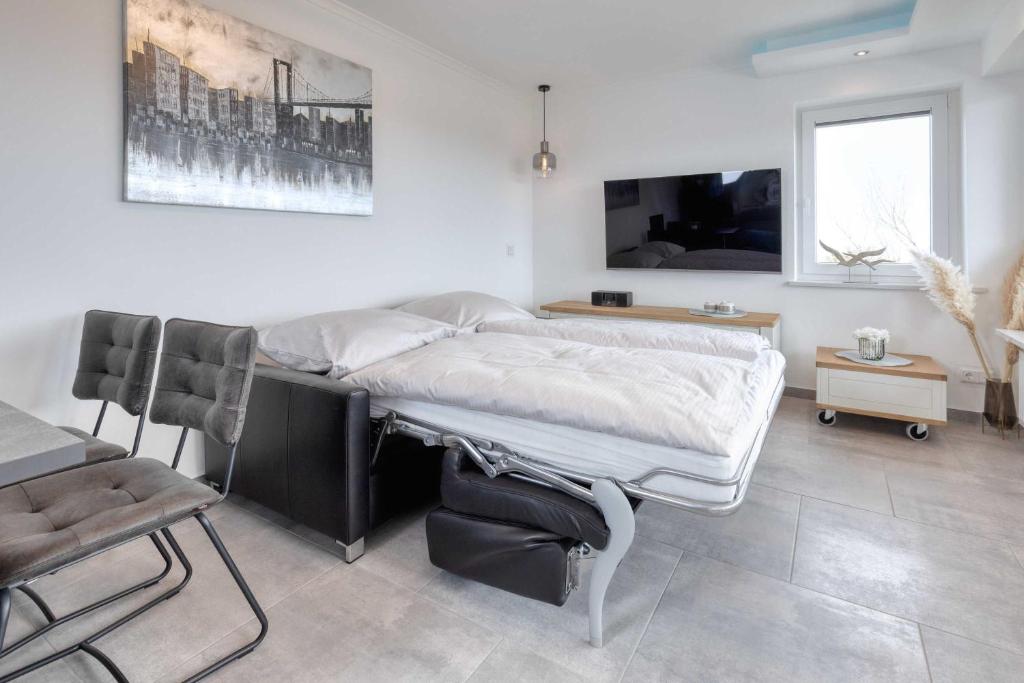 TV a/nebo společenská místnost v ubytování Terrassenhaus Duhnen Wohnung 77