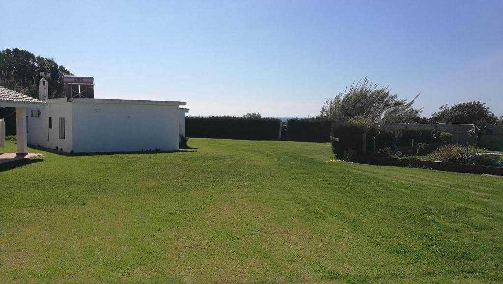 a large yard with a white house and a fence at Casas Miramar in Tarifa