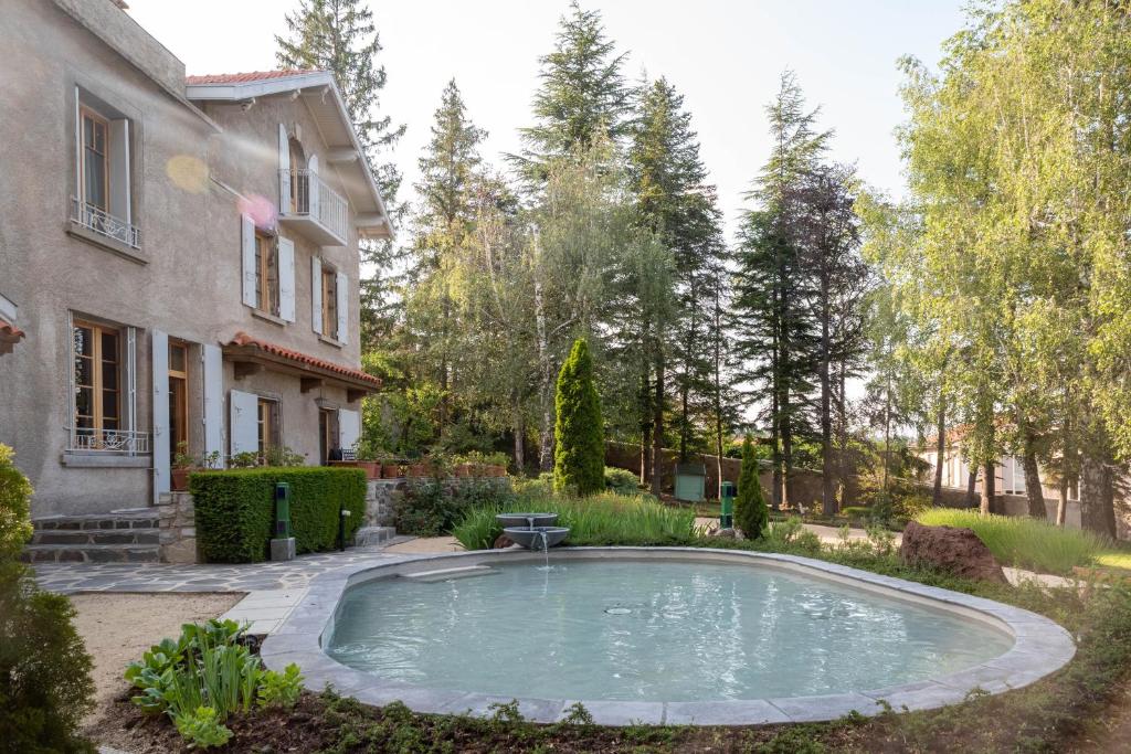 a swimming pool in the yard of a house at La Maison de Mireille in Le Puy-en-Velay
