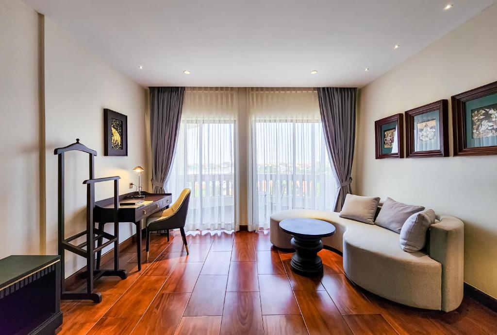 a living room with a couch and a table at Borei Angkor Resort & Spa in Siem Reap