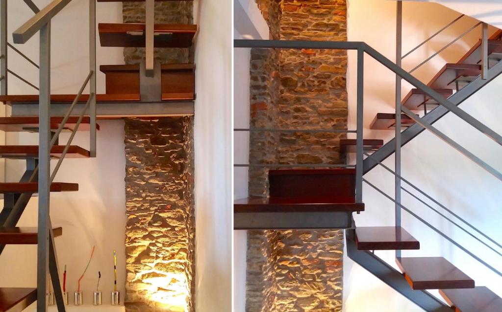 a staircase in a house with a stone wall at AMAZING LANGHE AND MONFERRATO | House with garden in Calamandrana