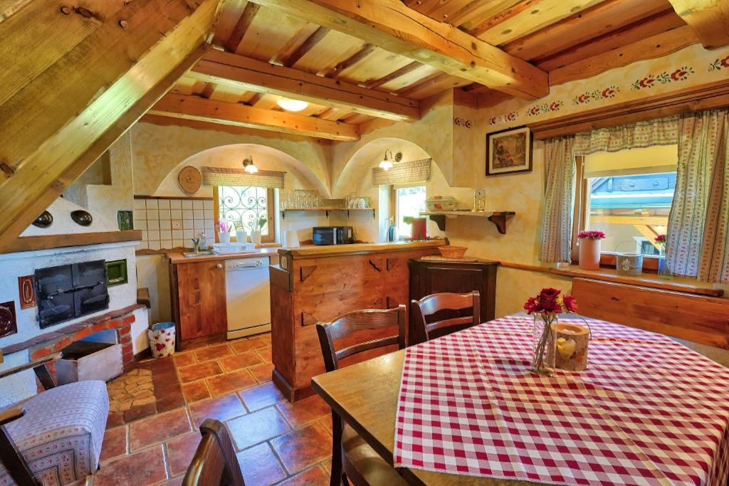 a kitchen with a table with a red and white table cloth at Betlehem Resort in Zgornje Gorje