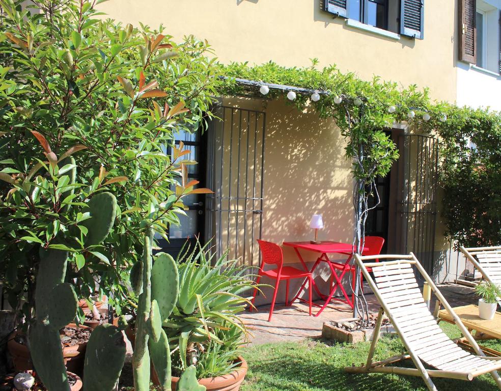 a patio with a table and chairs in a garden at AMAZING LANGHE AND MONFERRATO | House with garden in Calamandrana
