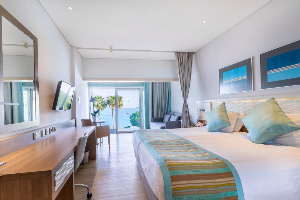a hotel room with a bed and a television at Crowne Plaza Limassol by IHG in Limassol
