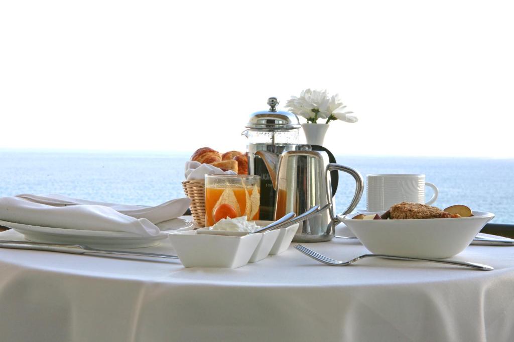 a table with a white table cloth with food on it at Crowne Plaza Limassol by IHG in Limassol