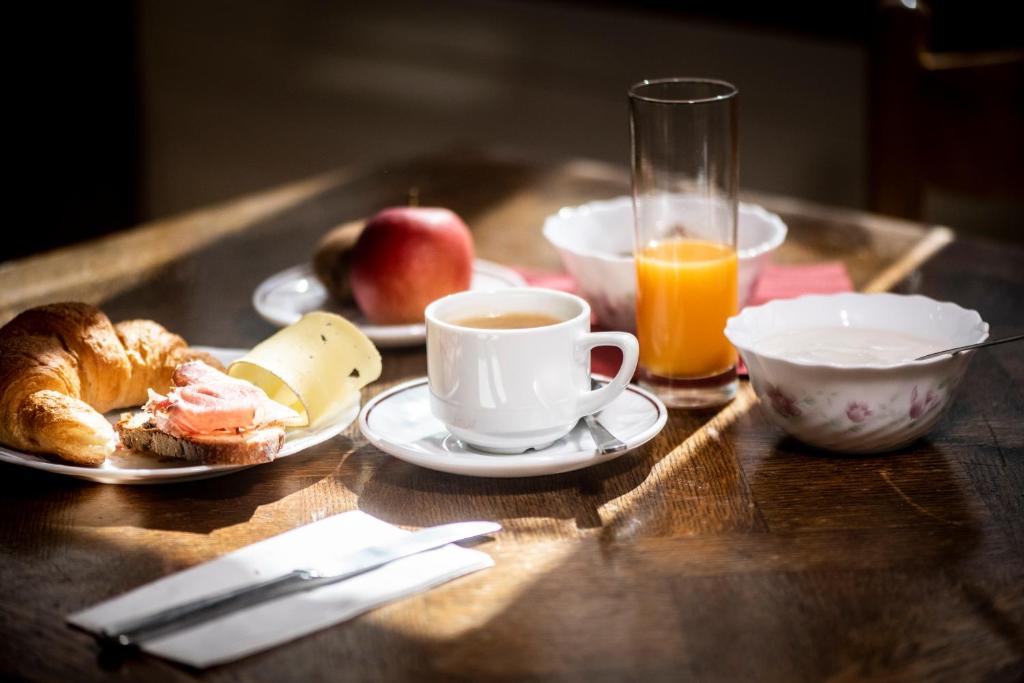 a table with a plate of food and a cup of coffee at Aiguille de La Tza in Arolla