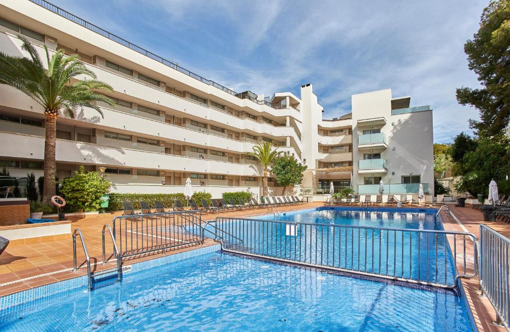 a large swimming pool in front of a building at Leonardo Suites Hotel Mallorca Calvia in Torrenova