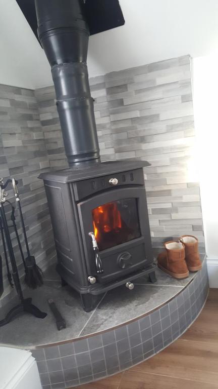 a stove in a room with a brick wall at Tobar Na Si Apartments in Letterkenny