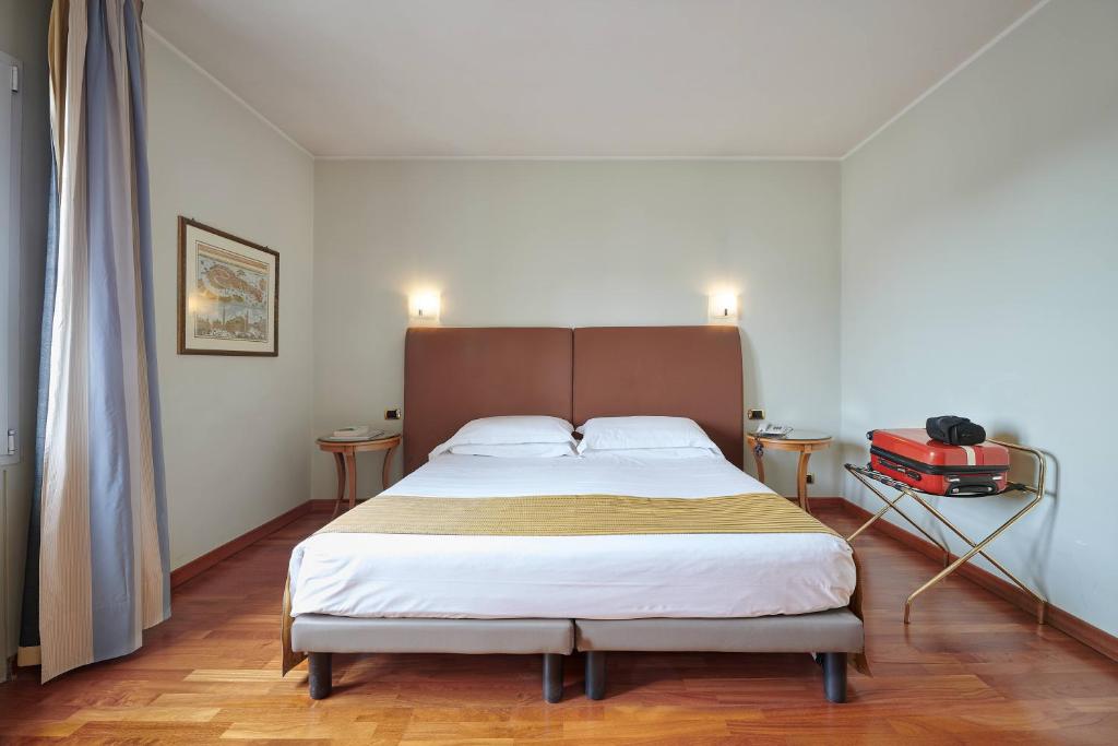 Postel nebo postele na pokoji v ubytování Hotel Plaza