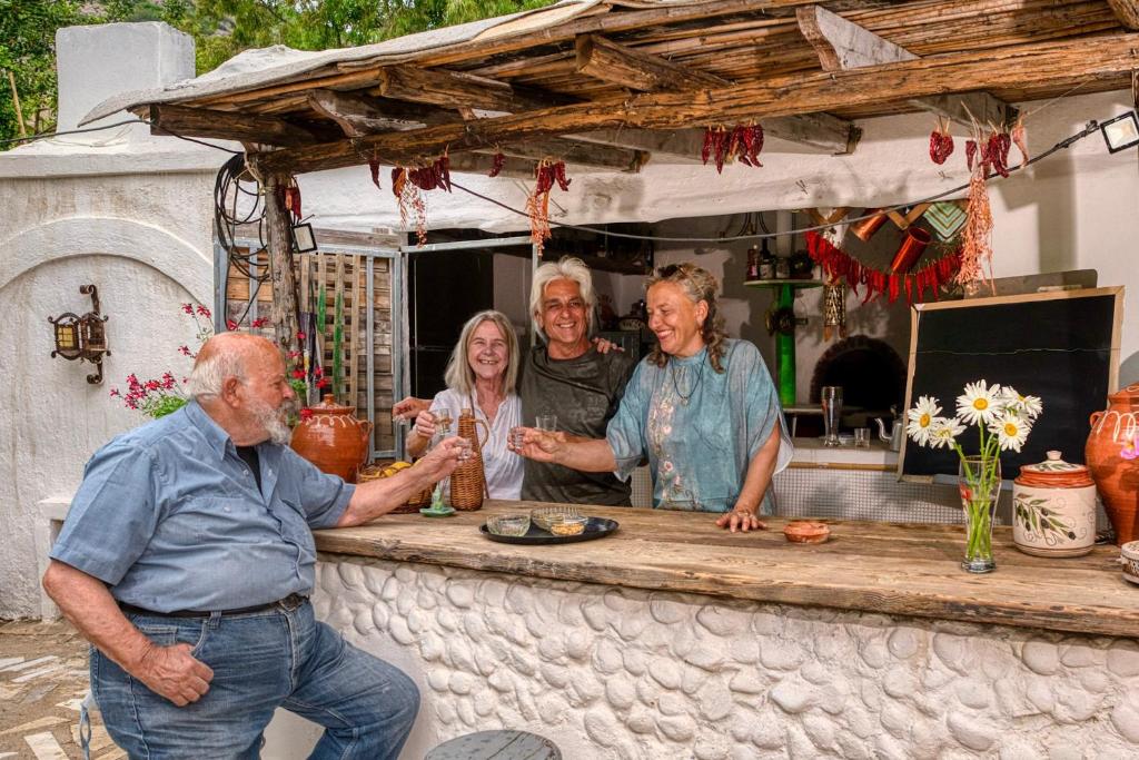 a group of people standing around a counter at AKTI ARGO in Palaiokastro