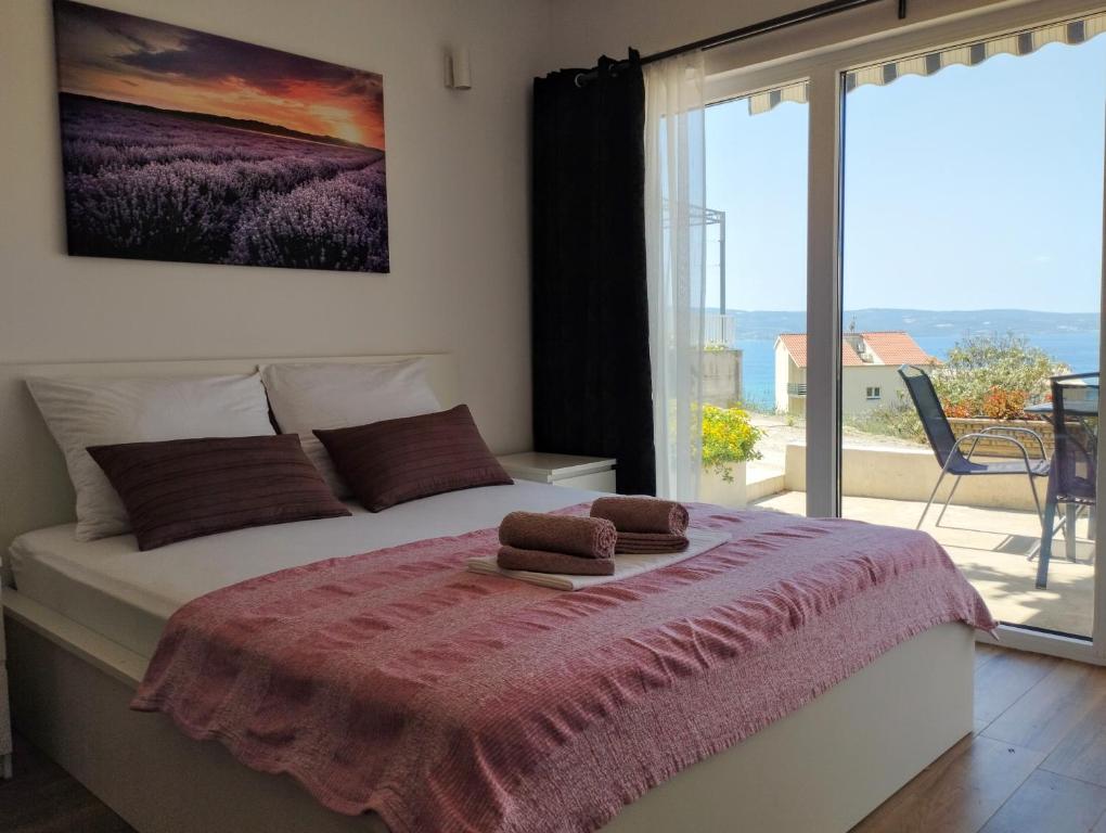 Postel nebo postele na pokoji v ubytování APARTMANI KUJUNDŽIĆ