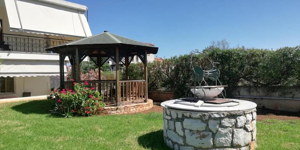 a gazebo with a fountain in a yard at Spata Efi's House in Spata