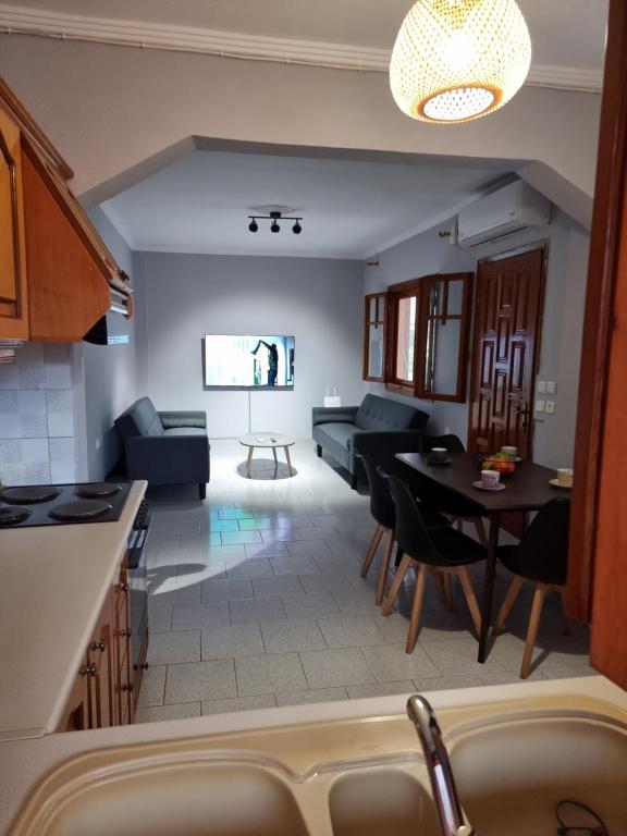 a kitchen and living room with a couch and a table at Meltemi Apartments in Asprovalta