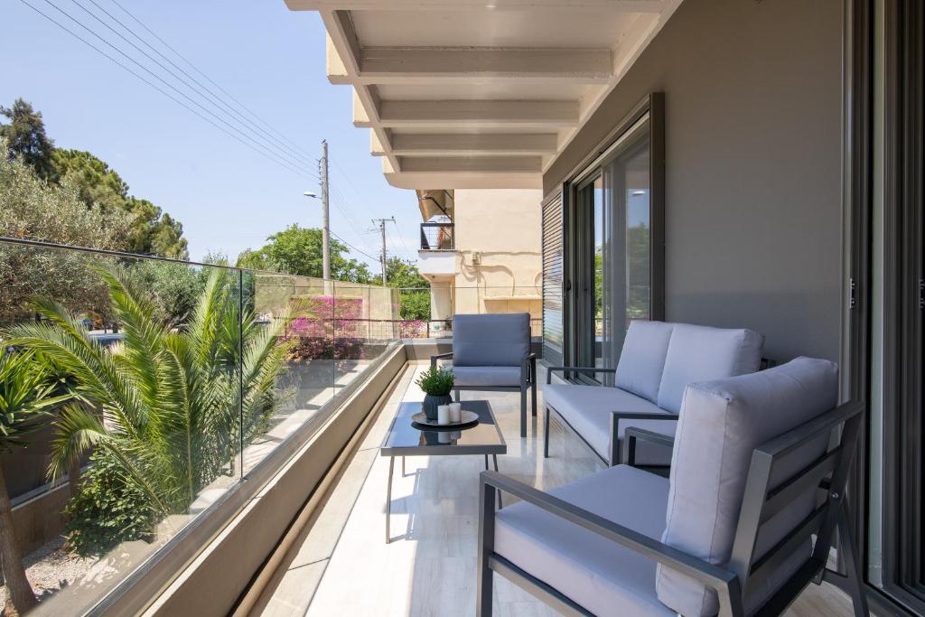 a balcony with chairs and a view of the ocean at Greyt Apartments Glyfada in Athens