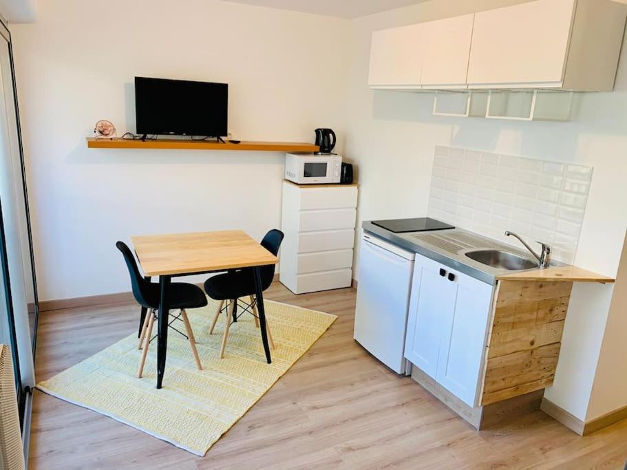 a small kitchen with a table and a sink at Le Port Tamaris in La Seyne-sur-Mer