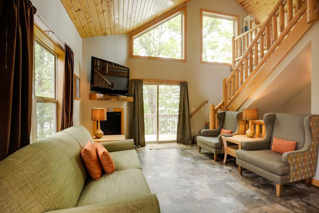 a living room with a couch and chairs and a tv at Lakefront Wisconsin Cabin Dock, Walk to Beach! 