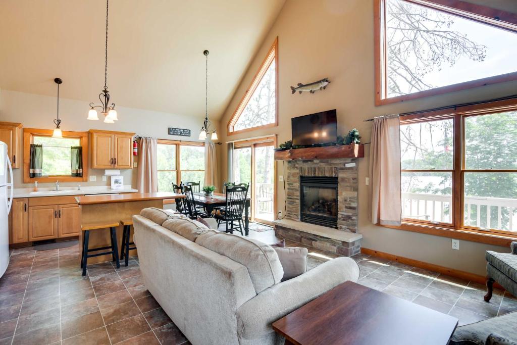 a living room with a couch and a fireplace at Lakefront Wisconsin Getaway with Kayak and Boat Dock! 